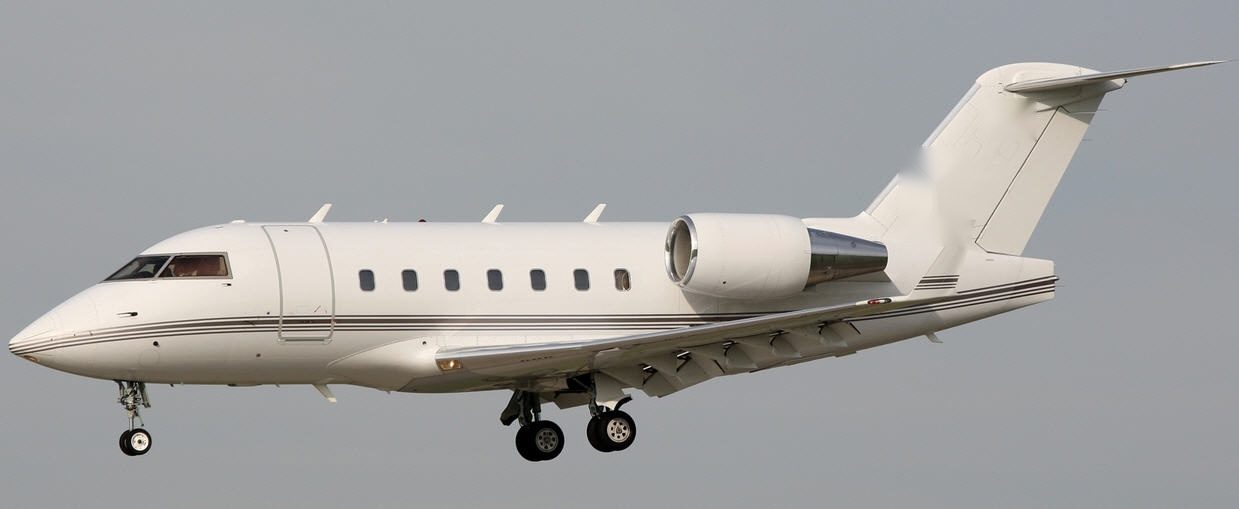 Bombardier Challenger 604 air ambulance jet taking off, exterior side view