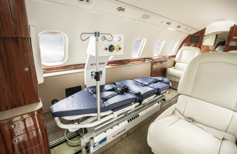Learjet 60 cabin fitted with a medical stretcher, IV pole and monitoring equipment