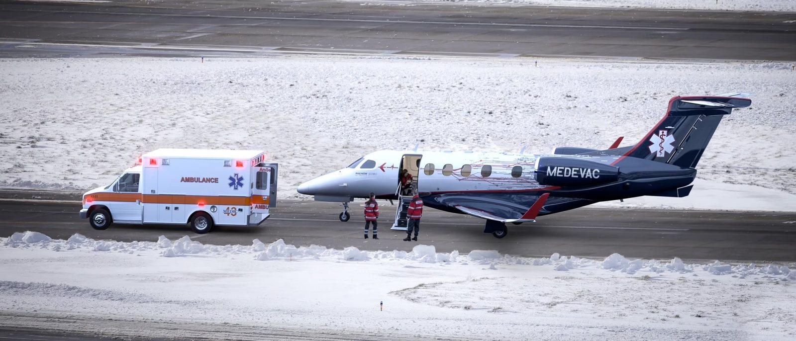 Air ambulance jet and ground ambulance on a snowy runway — Ski Accident Abroad: Repatriation and Care