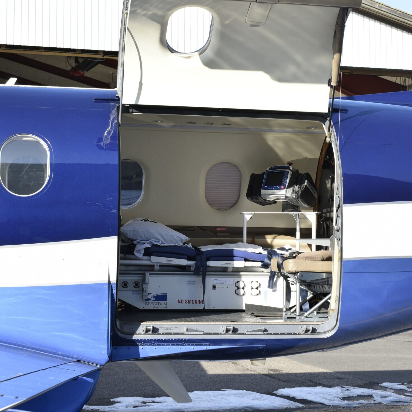 Air ambulance turboprop with its cabin door open, showing a stretcher and a medical monitor — Why Does the Price of an Air Ambulance Vary So Much?
