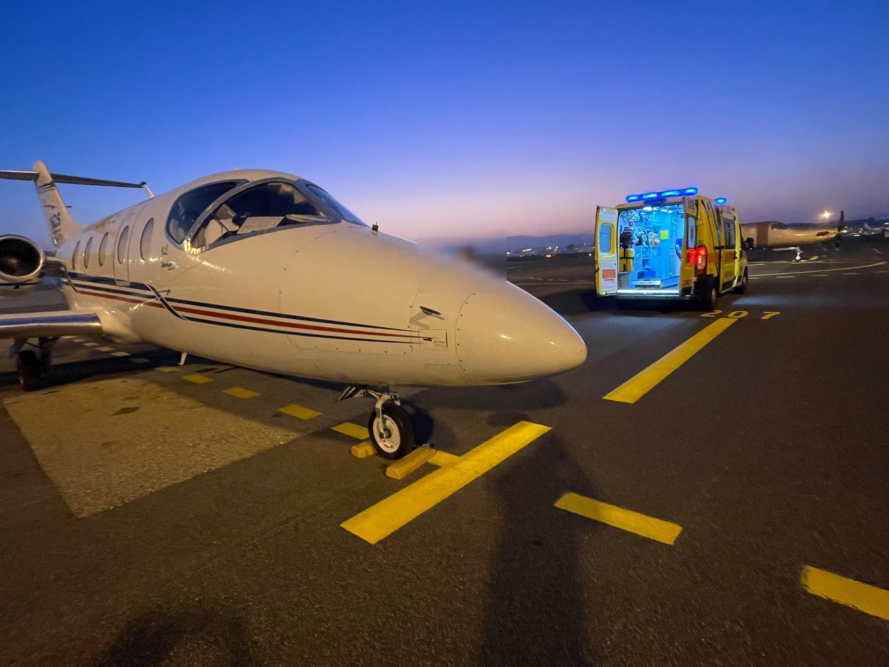 Air ambulance jet and ground ambulance on the tarmac at dusk during a real repatriation mission