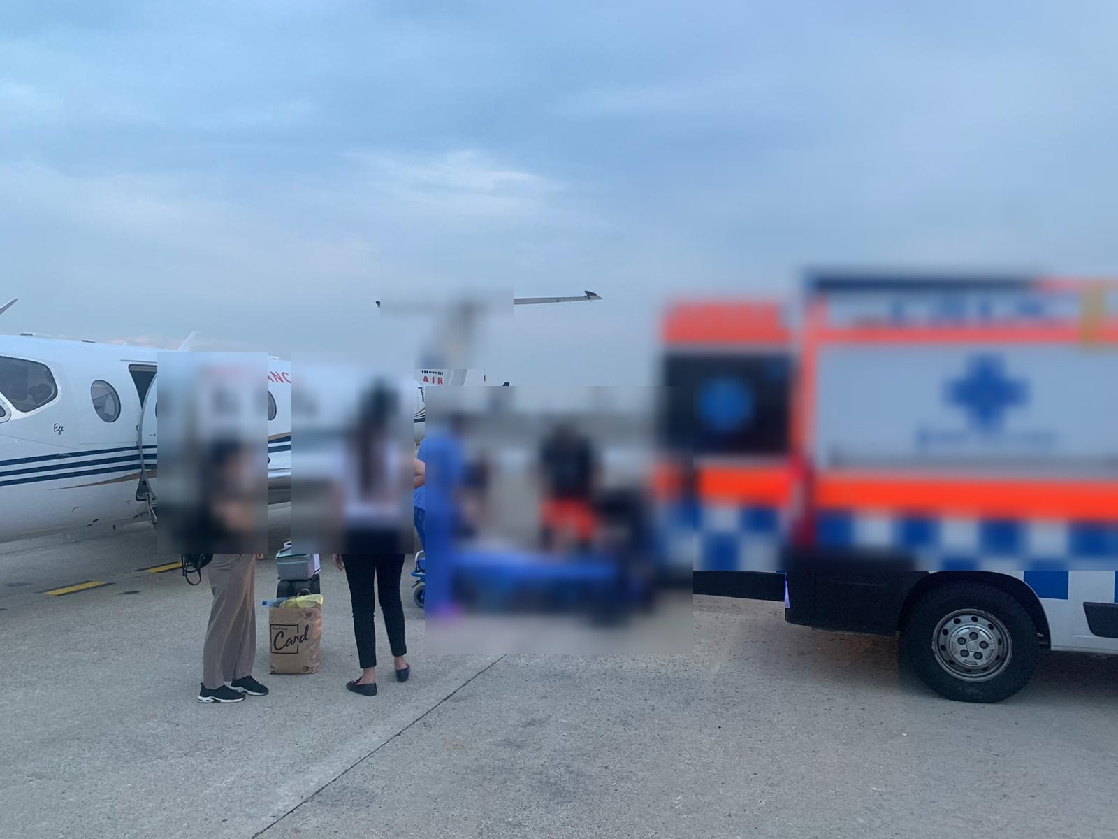 Ground ambulance and air ambulance jet during a patient handover coordinated with a partner assistance company