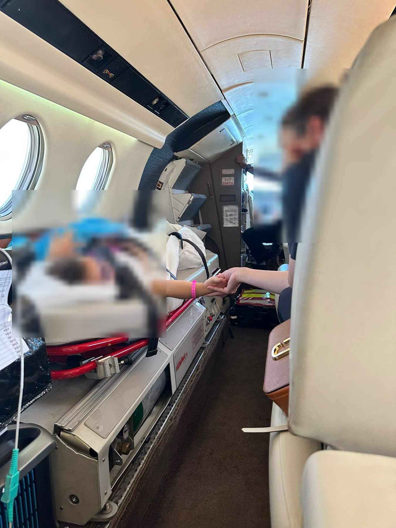 Medical crew member attending to a young patient before boarding the air ambulance